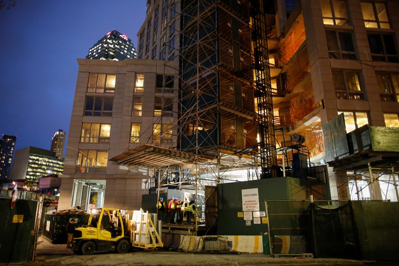 People work at a building construction site in Long Island City, where Amazon.com is reportedly