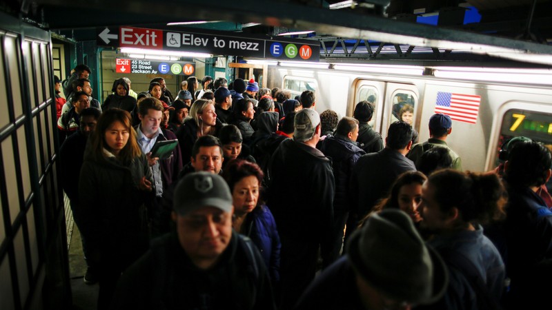 People wait for the arrival of 7 train in Long Island City, where Amazon.com is reportedly