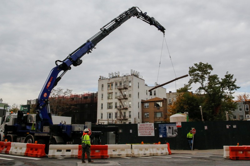 People work at a building construction site in Long Island City, where Amazon.com is reportedly