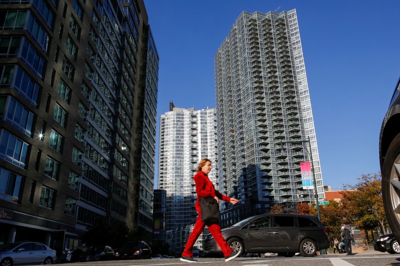 A woman walks on a street in Long Island City, where Amazon.com is reportedly considering as