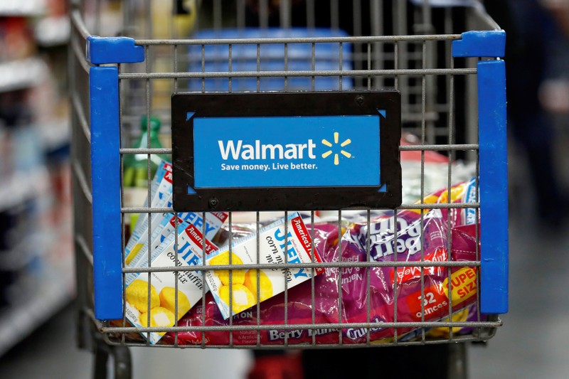 A customer pushes a shopping cart at a Walmart store in Chicago