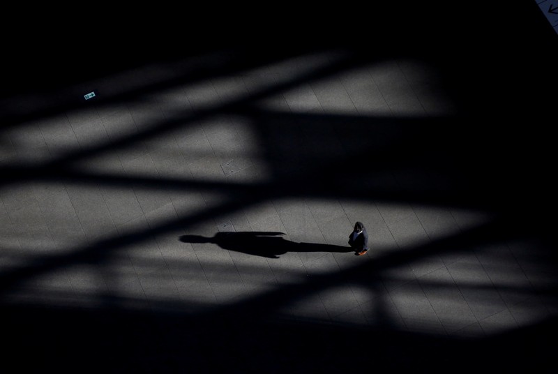 FILE PHOTO - A man makes his way at a convention centre in a financial district in Tokyo
