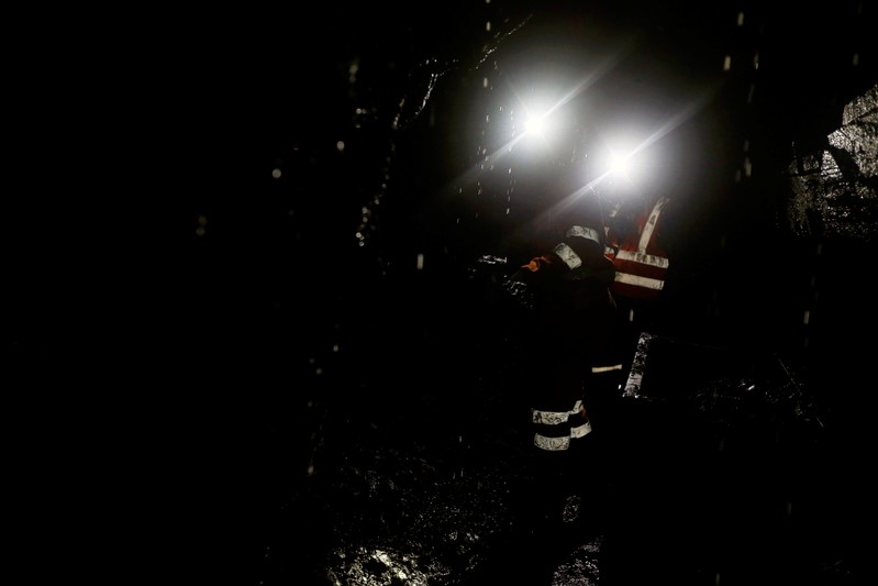 Formal miners walk inside one of the mines of the company Fura in Coscuez