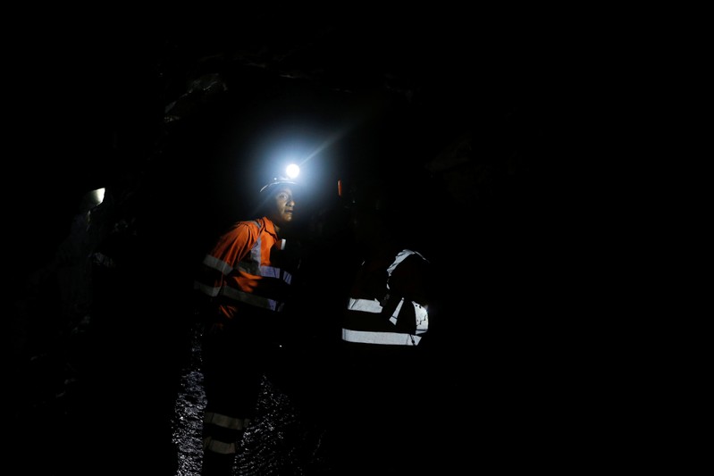 Formal miners walk inside one of the mines of the company Fura in Coscuez