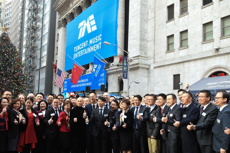 Executives of Tencent Music Entertainment celebrate the company's IPO outside the New York