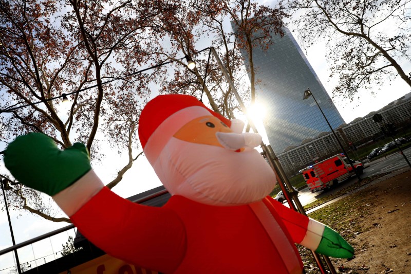 A giant inflatable spatial object depicting Santa Claus is seen near ECB headquarters in