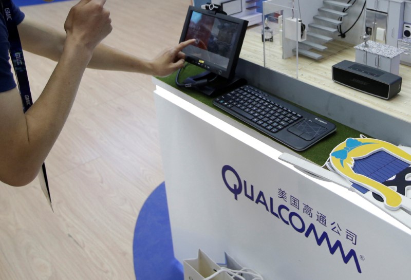 A man visits Qualcomm's booth at the GMIC in Beijing