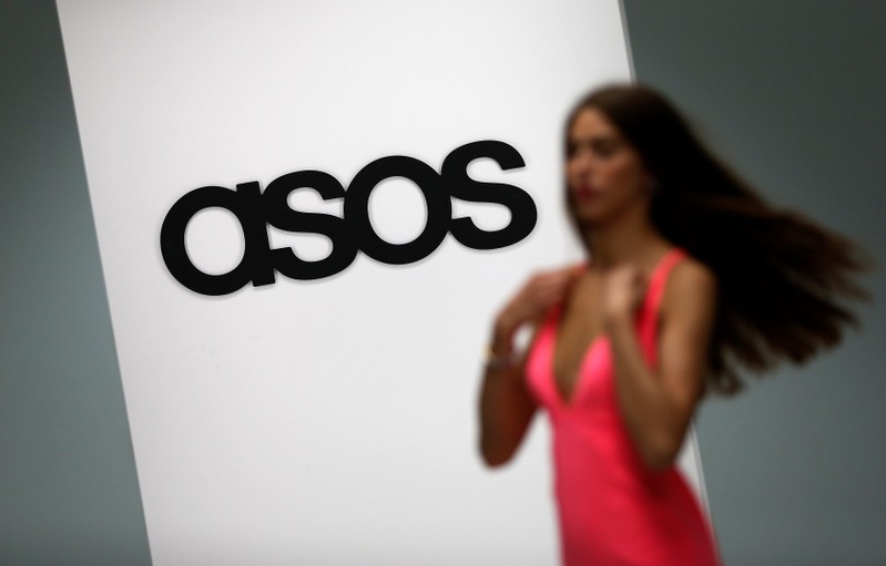 FILE PHOTO: A model walks on an in-house catwalk at the ASOS headquarters in London