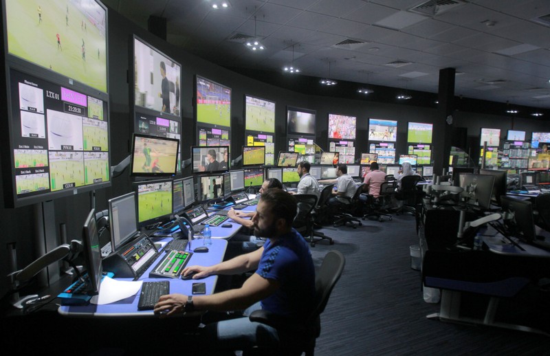 Employees work in a broadcast control room at the beIN Sports studio that will be hosting the