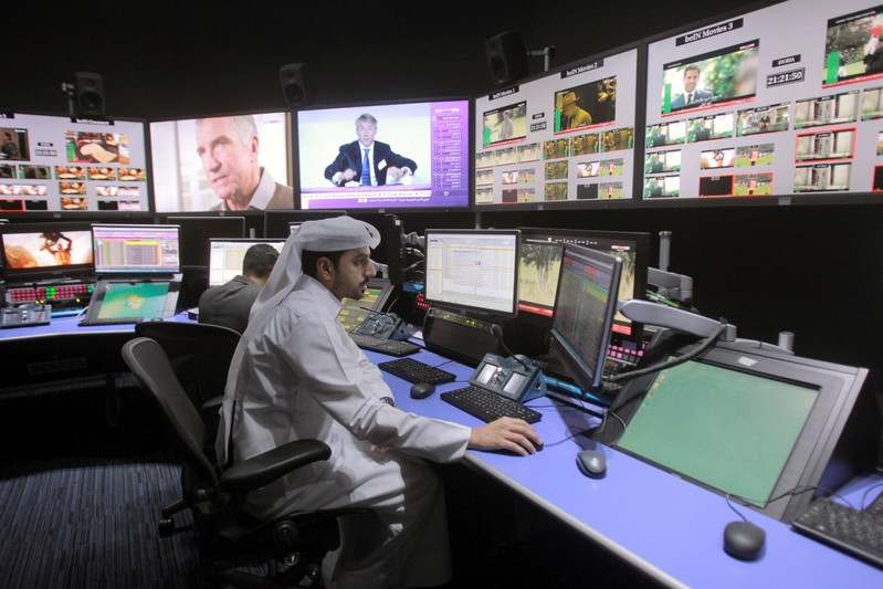 Employees work in a broadcast control room at the beIN Sports studio that will be hosting the