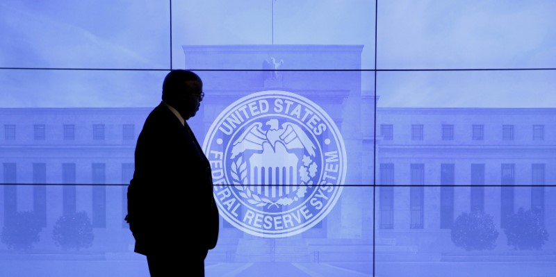 FILE PHOTO: A guard walks in front of a Federal Reserve image before press conference in