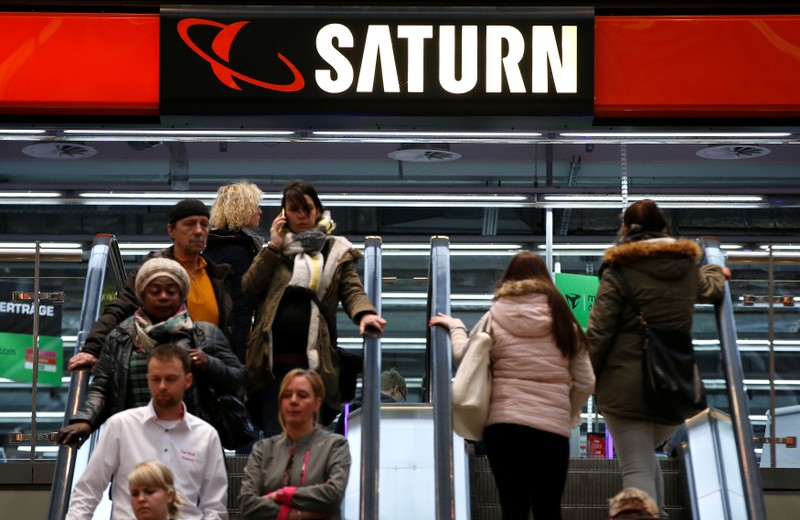 FILE PHOTO: People use escalators at a Saturn electronic retailer inside a shopping mall in