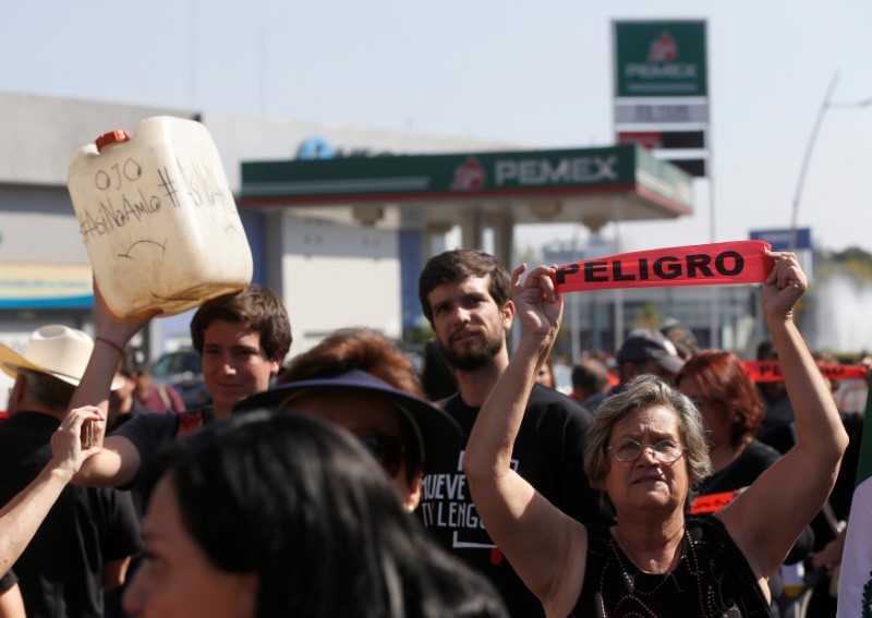 People take part in a protest against fuel shortages near a gas station in Guadalajara, Jalisco