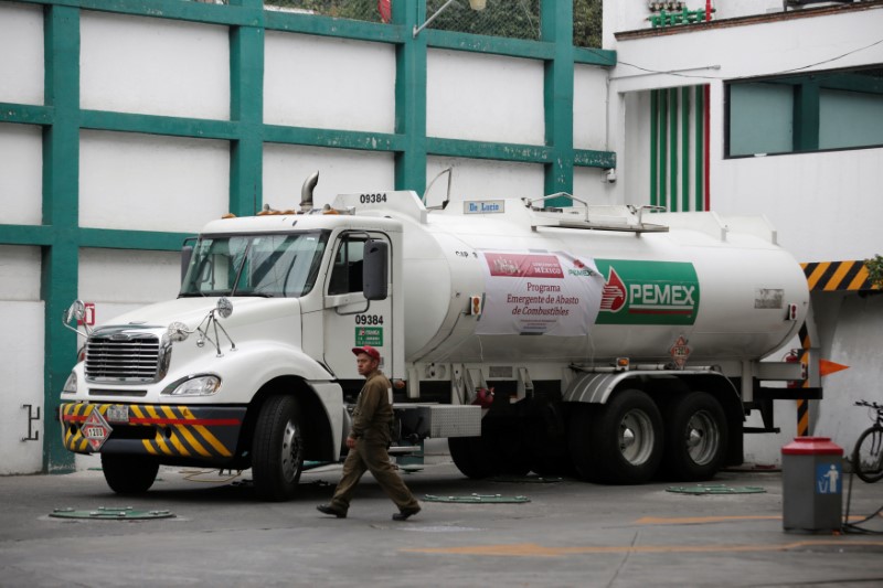 A fuel truck arrives at a gas station to supply in Mexico City