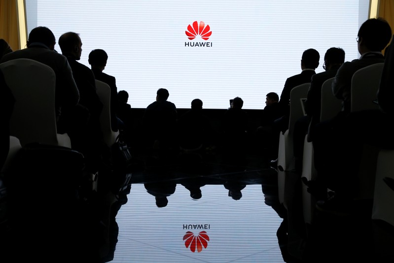 People attend a product presentation at Huawei in Beijing