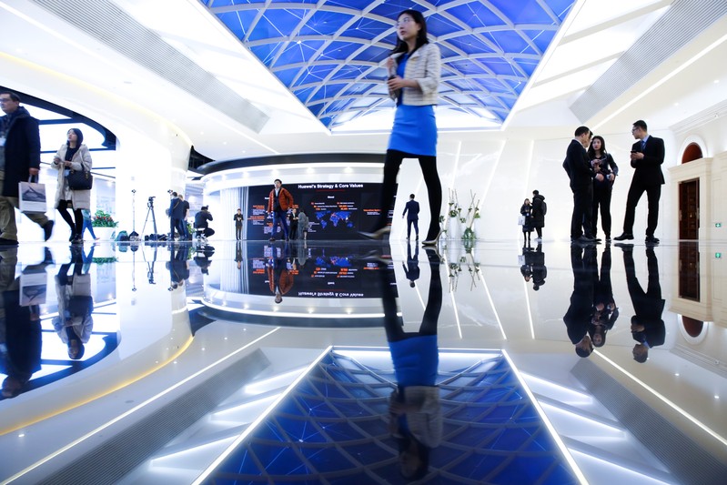 People arrive for a product presentation at Huawei in Beijing