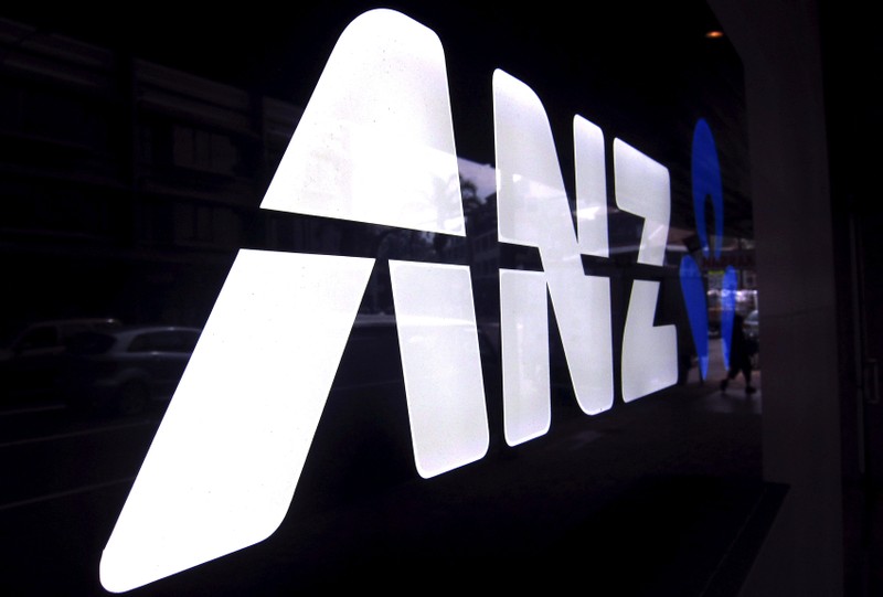 FILE PHOTO: A man walks past a branch of the Australia and New Zealand Banking Group Ltd (ANZ)