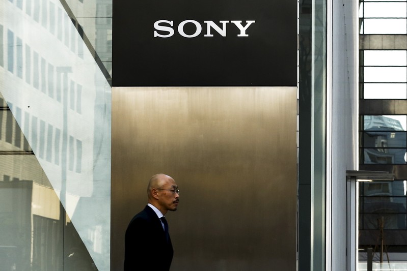 A man walks past the company of Sony Corporation outside its headquarters in Tokyo