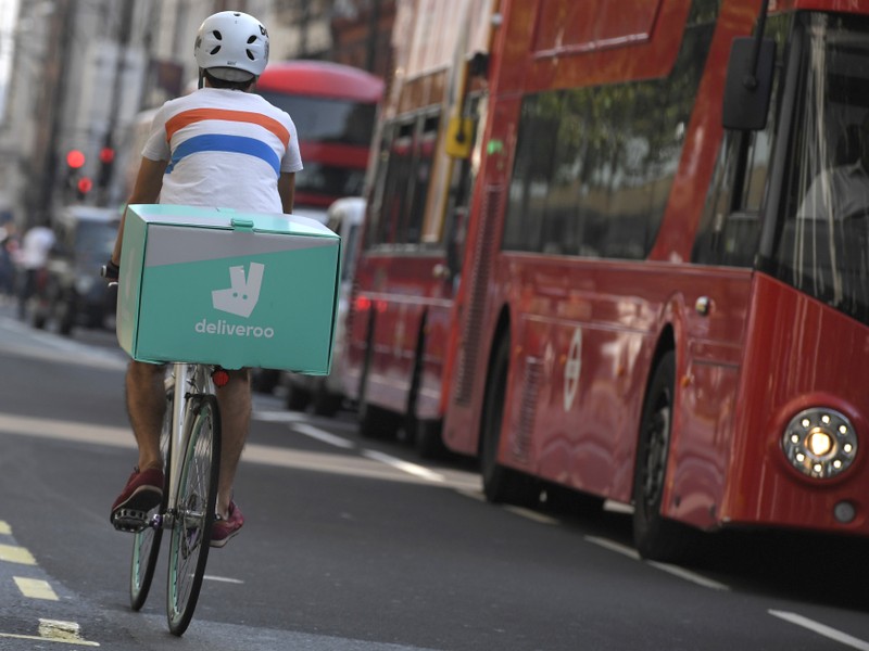 FILE PHOTO: A cyclist delivers food for Deliveroo in London, Britain
