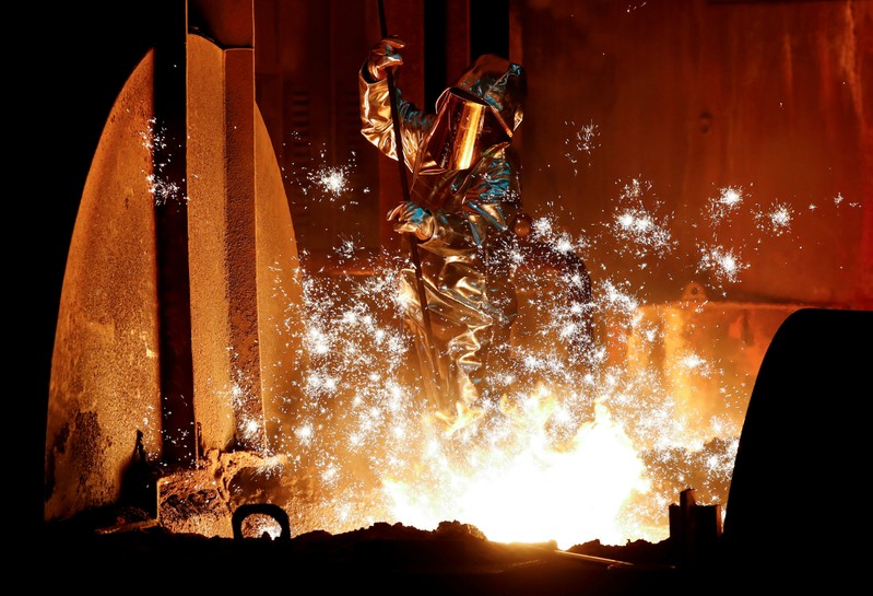 FILE PHOTO: A steel worker of Germany's industrial conglomerate ThyssenKrupp AG takes a sample