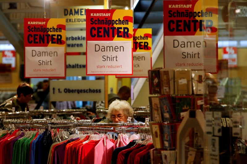 FILE PHOTO: Shoppers look for goods in a Karstadt hot deal department store in  in