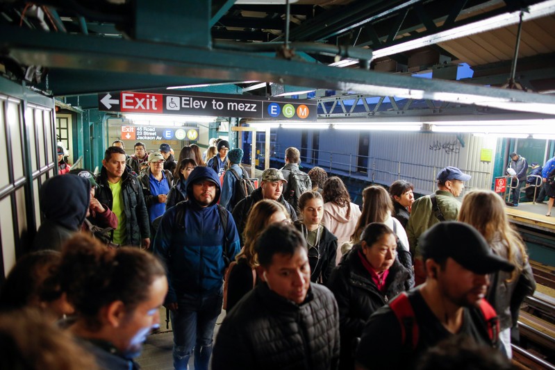 People wait for the arrival of 7 train in Long Island City, where Amazon.com is reportedly