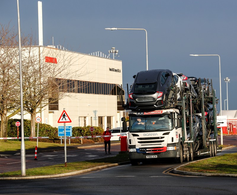 A lorry with car carrier trailer leaves the Honda car plant in Swindon