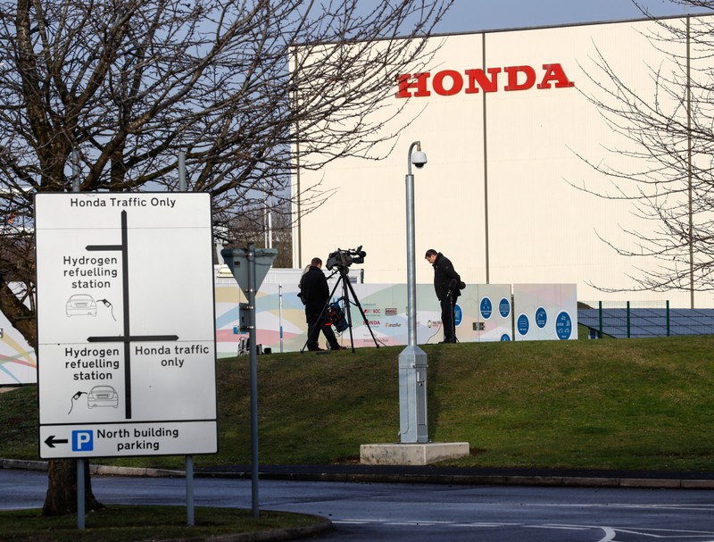 Members of media stand outside the Honda car plant in Swindon