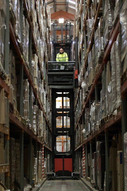 FILE PHOTO: An employee operates a forklift to move goods at the Miniclipper Logistics