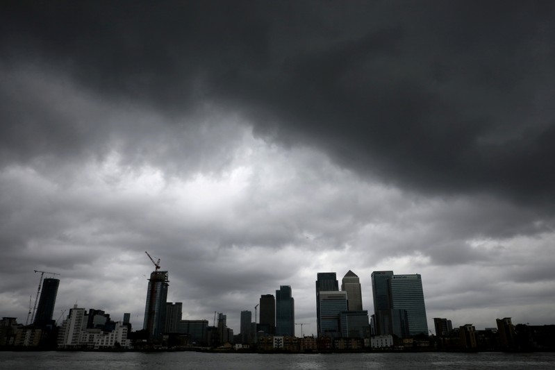 FILE PHOTO: Rain clouds pass over Canary Wharf financial financial district in London
