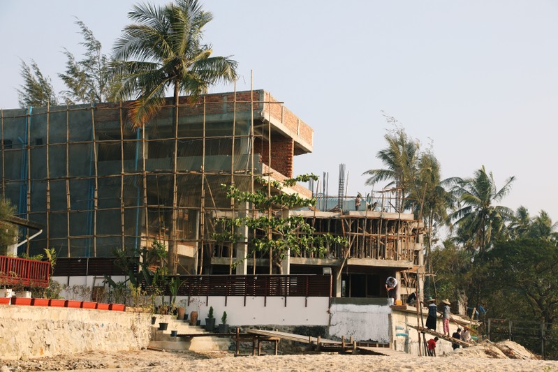 Workers are seen at a hotel construction site at Ngapali beach in Thandwe