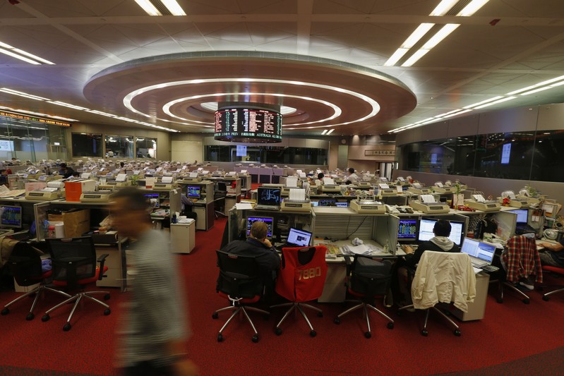 Floor traders monitor share pries during afternoon trading at the trading hall of the Hong Kong