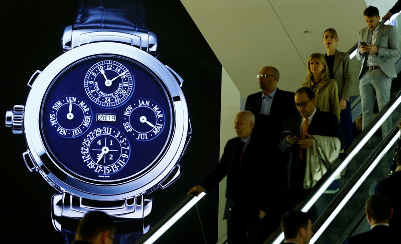 Visitors are seen in front of a display of Swiss watch manufacturer Patek Philippe at the