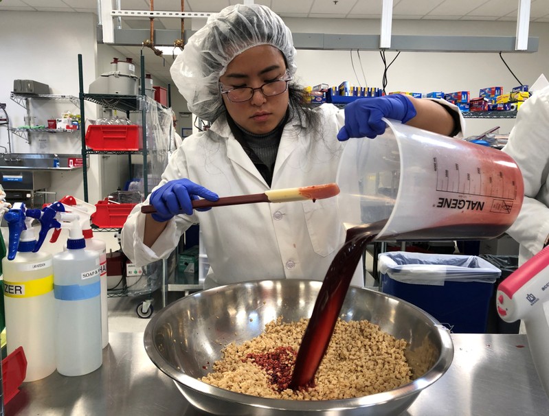 Impossible Foods research technician Alexia Yue pours a heme solution into a plant-based