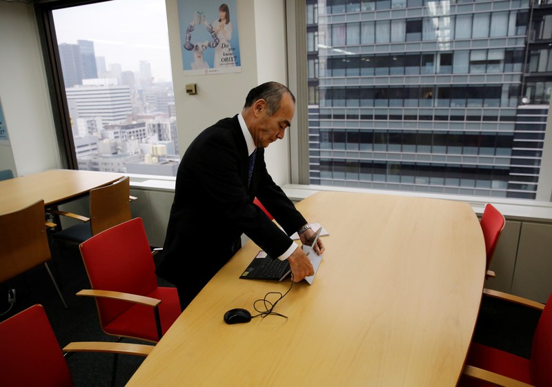 Yasuhiro Furuse, a senior adviser of corporate sales headquarters of Orix Corp., unfolds his