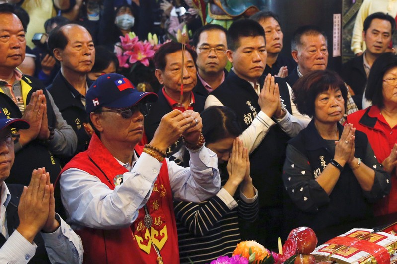 Terry Gou, founder and chairman of Foxconn, prays at a temple, in New Taipei City