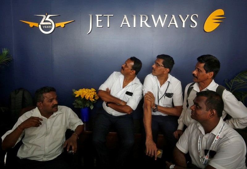 Jet Airways employees sit at the front desk at its headquarters in Mumbai
