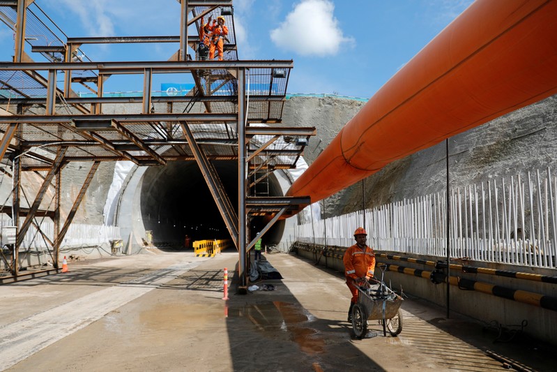 A worker pushes a wheelbarrow at Walini tunnel construction site for Jakarta-Bandung High Speed