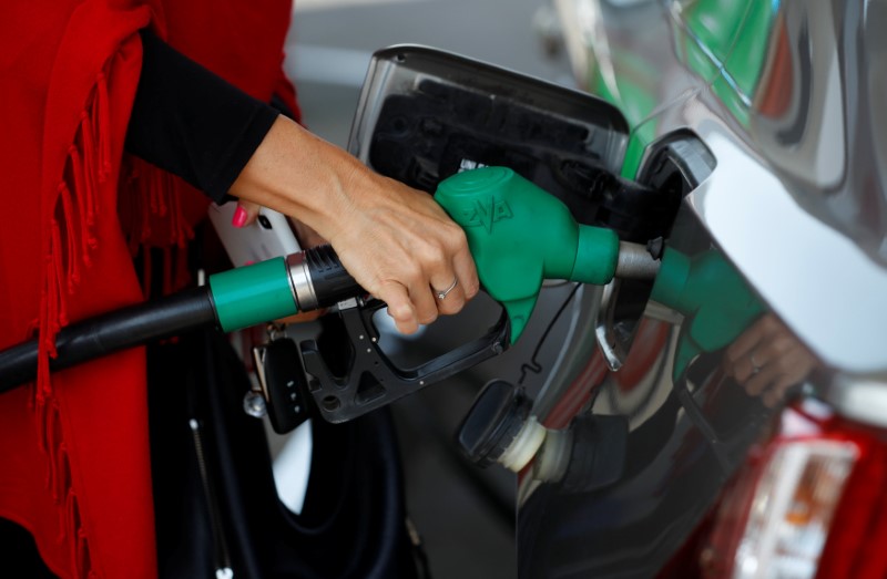 Woman refuels a car at PKN Orlen petrol station in Warsaw