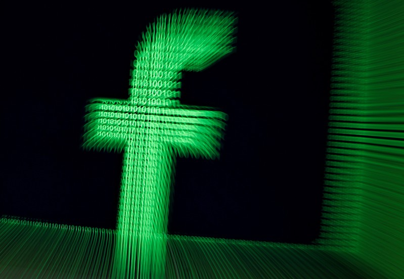 FILE PHOTO: A 3D-printed Facebook logo are seen in front of displayed binary digits in this