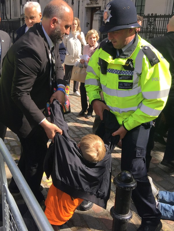 Climate change protesters are dragged away by security outside Barclays annual investor meeting