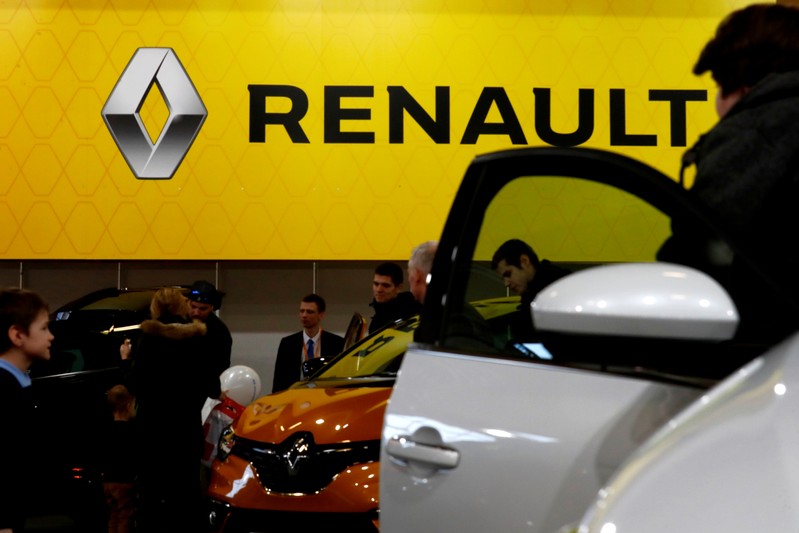 FILE PHOTO: People look on Renault cars during the international motor show Auto 2019 in Riga