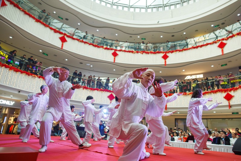 People perform a tai chi routine at a department store in Zhengzhou