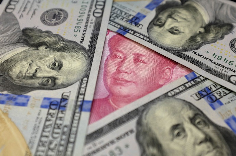 FILE PHOTO: U.S. 100 dollar banknotes and a Chinese 100 yuan banknote are seen in this picture