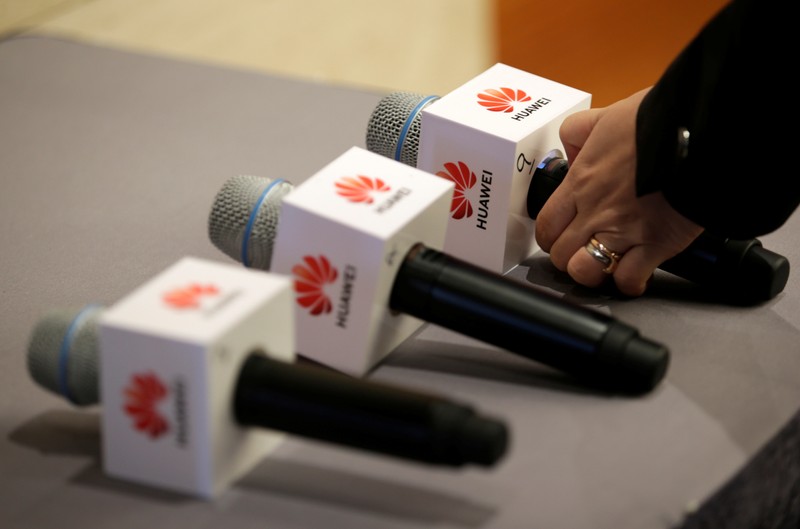 An employee prepares for a news conference on Huawei’s ongoing legal action against the U.S.