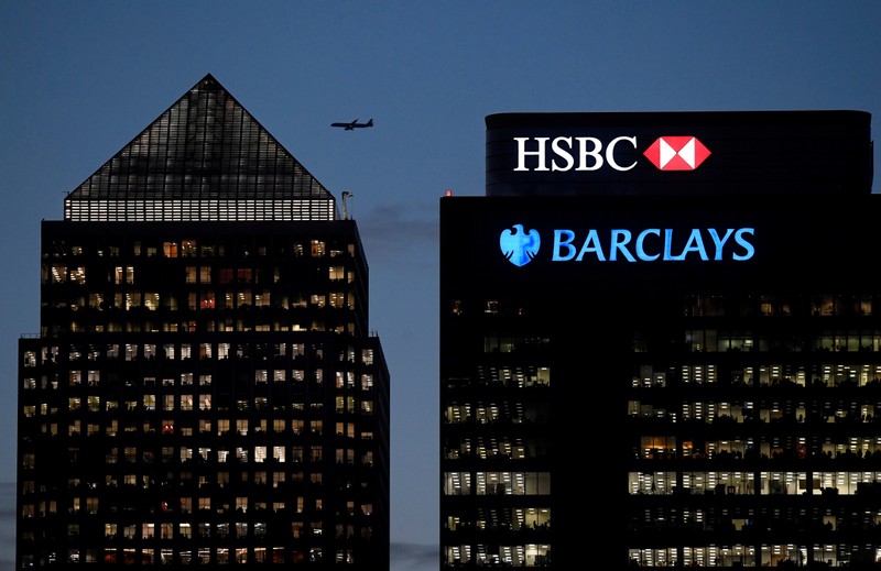 FILE PHOTO: Workers are seen in offices of HSBC and Barclays bank in the Canary Wharf financial