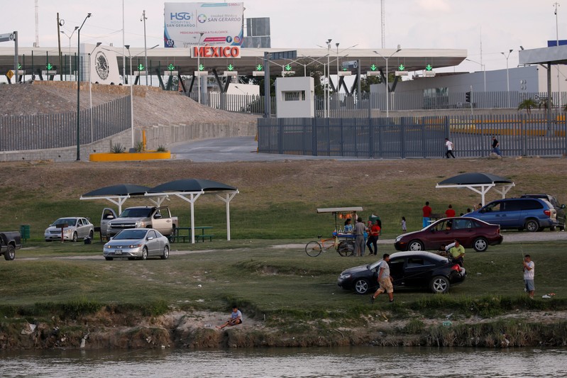 Mexicans enjoy the afternoon on the shore of Rio Bravo near the border, as is seen from Laredo,