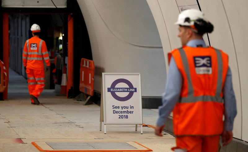 FILE PHOTO: Crossrail employees walk in the new Farringdon underground station of the Elizabeth