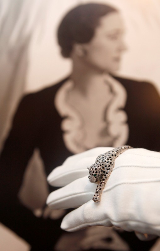 FILE PHOTO: An employee from Sotheby's jewellery department, holds an onyx and diamond panther