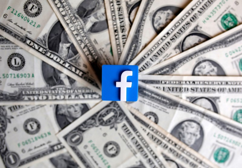 FILE PHOTO: A 3-D printed Facebook logo is seen on U.S. dollar banknotes in this illustration